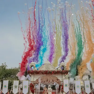 A sky painted with the colors of your love. This is how I make your varmala moment iconic, using vibrant smoke effects to create a backdrop as unique and beautiful as your story.