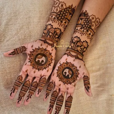A perfect example of a design that is both minimalist and rich in detail. This Karwachauth henna features a central elephant mandala on the palm, leaving negative space for a clean, modern feel while still honoring tradition.