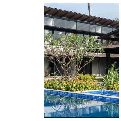 A home in Alibaug, where the pool reflects the lush greenery. Our designs for this region feature high roofs for thermal release and simple verandahs for country living.