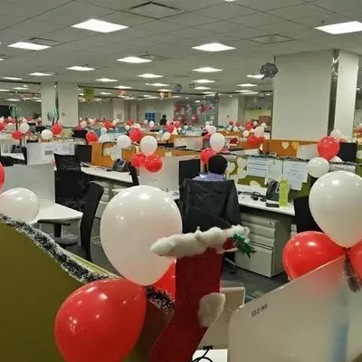 For this corporate party, I decorated the entire office floor with red and white balloons. The balloons are attached to cubicles and desks to ensure the whole space feels festive.