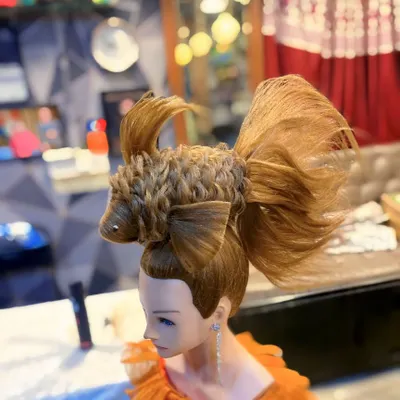 An example of my creative hairstyling work, a fish sculpture made entirely of hair. This avant garde piece showcases advanced techniques in hair shaping and texturing.