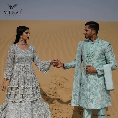 I designed this sea-green Indo-Western sherwani to be a realm of elegance. It is paired with a double-layered bridal silhouette, both crafted with astonishing silver zardozi work for a magnificent, coordinated look.