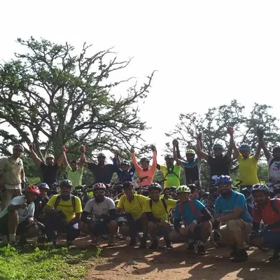 Victory poses are a must after a fun trail ride. The whole group celebrating together in the middle of the Nallur Tamarind Grove.