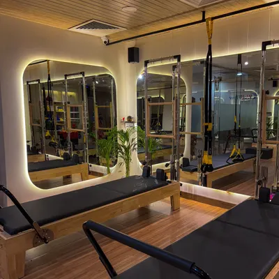 A glimpse into our beautiful, newly opened studio in GK 2, Delhi. The space is designed with modern aesthetics, featuring backlit mirrors and clean lines to create a calming and motivational atmosphere.
