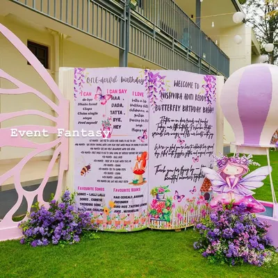 A personalized storybook welcome sign for Nishvika's butterfly birthday, complete with a giant butterfly wing prop for the perfect photo opportunity.