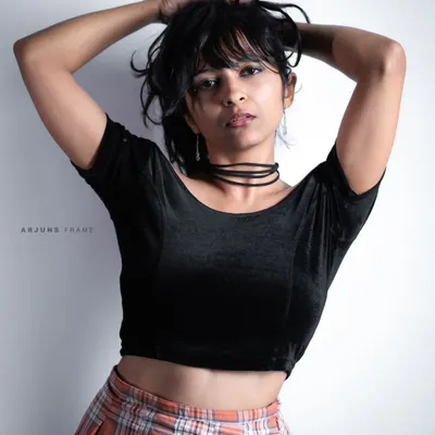 A direct and intense look from my 'Grunge & Glory' series. The messy hair and simple black top create a raw, powerful image perfect for alternative fashion modeling.