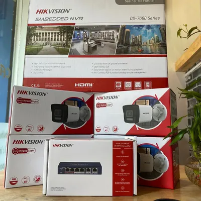 This is a standard professional security kit we provide, featuring a Hikvision NVR, 4MP IP cameras with audio recording, and a POE switch. This setup allows both power and data to be sent over a single ethernet cable, simplifying installation.