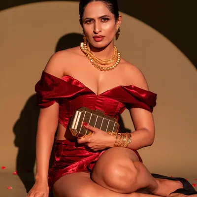 A bold and glamorous shot featuring a velvet co-ord set. The spotlight lighting technique creates a dramatic, high-fashion look, perfect for a magazine-style portrait.