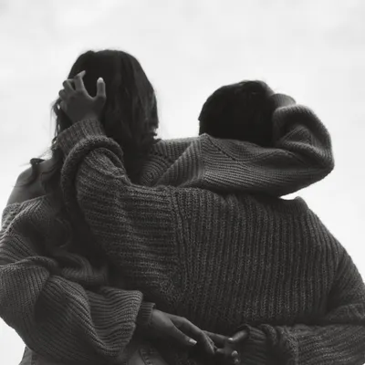 An at-home session is perfect for capturing genuine intimacy. This black and white close-up focuses on the texture and feeling of a simple embrace, stripping away everything but the emotion.
