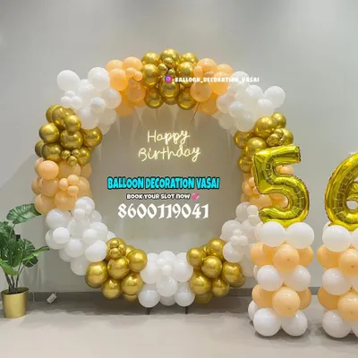 This elegant circular balloon frame was for a 56th birthday celebration in an office space. The mix of chrome gold, peach, and white balloons creates a sophisticated photo backdrop, complete with large foil numbers.