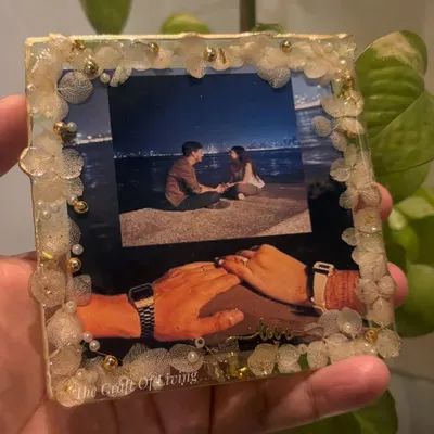 One frame, endless emotions. This custom resin photo frame turns your favorite picture into a timeless keepsake, bordered with delicate fabric flowers and pearls.