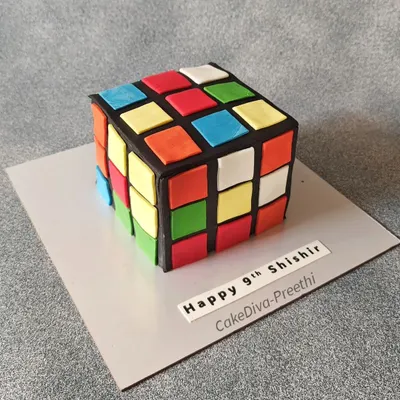 Rubik's Cube or cake? This was a fun challenge. I carved a square chocolate truffle cake and covered it with black fondant, then carefully placed each colored square to replicate the iconic puzzle.