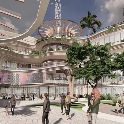 A rendering of the central plaza at Inorbit Vizag, showing a multi-level retail and leisure space with organic architectural forms and integrated greenery. The design creates a shared public ground that connects different programs and encourages community interaction.