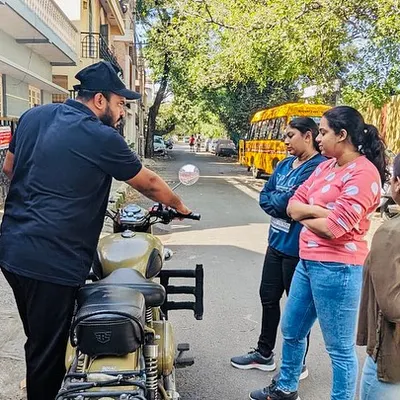 Personal instruction is key. Here, I'm explaining the bike's controls to a small group of new learners, ensuring everyone is comfortable and understands the basics before we start riding.
