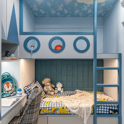 A close-up of the custom-built bunk bed, designed to look like a ship or submarine with its porthole details. The upper bunk is a fun play space, while the lower bunk is a cozy sleeping area with a padded headboard.