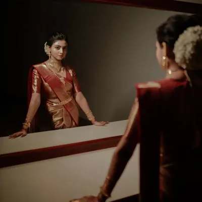 A dramatic and artistic bridal portrait, capturing the bride's reflection as she prepares for her big day.