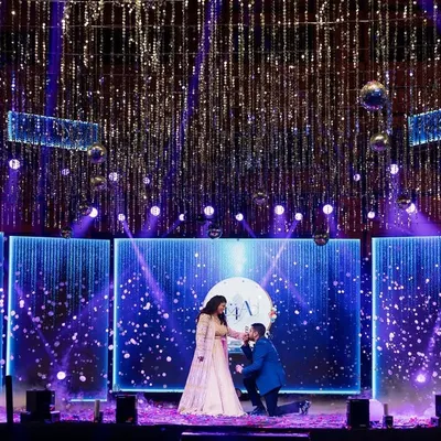 A fairytale proposal moment during the Sangeet. We help script these romantic interludes, complete with dramatic lighting and a stage that makes you feel like the only two people in the world.