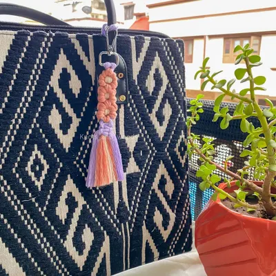 How sweet is this little flower keychain? 🌸 I made this macrame charm with two-toned petals and a tassel. It's a perfect way to add a touch of handmade beauty to your everyday bag or keys.