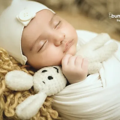 A close-up on pure innocence. This newborn is sleeping soundly, cuddled up with a tiny crocheted bunny, showcasing the delicate features I love to capture.