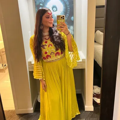 A client looking like a ray of sunshine in this yellow embroidered outfit. She paired it with a delicate white choker and matching earrings, creating a beautiful and bright festive look.