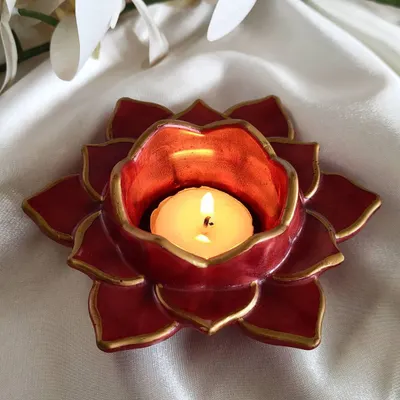 This red and gold lotus T-light holder was a popular item for Diwali. The rich color and hand-painted gold edges bring a traditional and festive feel to your home.