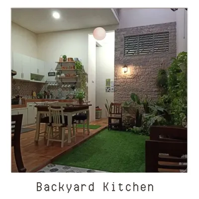 We can integrate green spaces anywhere in your home, even next to the kitchen. This design shows how a small patch of green with a brick accent wall can bring life and a natural feel to an indoor dining area.