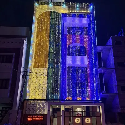 The Samyama Foundation Spiritual Centre illuminated at night for its inauguration. This striking image showcases the completed building, a multi-story beacon of light and spirituality in Bangalore.