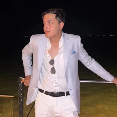 A client enjoying an evening by the water in an arctic blue linen jacket. This is the perfect look for a destination wedding or a landmark birthday party, effortlessly stylish and comfortable.