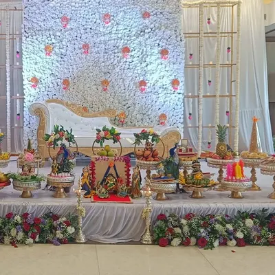 A full platter setup for a beautiful ceremony at the Hennur Cosmopolitan Club. The arrangement is designed to complement the floral backdrop and create a complete, elegant look on stage.