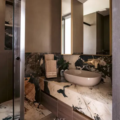 Powder rooms are an opportunity to be bold. Here, I used a dramatic, veiny marble for the countertop and backsplash, creating a powerful focal point that feels both artistic and luxurious.