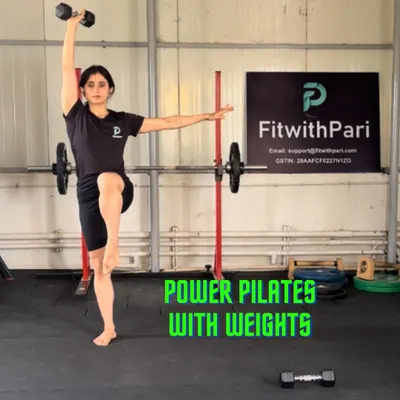 This is Power Pilates, where we use weights to add a new layer of challenge. This standing single-leg hold with an overhead press targets balance, core stability, and shoulder strength all at once.