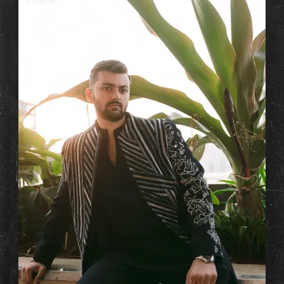 A groom's portrait just before the Sangeet madness begins. This shot captures Kushal looking sharp and ready for the celebration, with a great blend of ambient light and stylish composition.