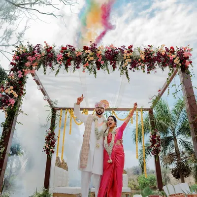 A vibrant varmaala ceremony with colorful smoke, creating a truly spectacular and modern moment. We love capturing both the tradition and the unique personality of your wedding.