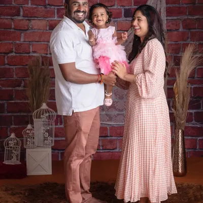 A full-length family portrait against our popular rustic brick wall. Their happy, interacting smiles create a photo that is both classic and full of life.