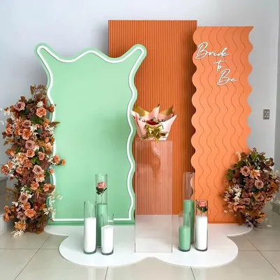 A modern and artistic "Bride to Be" setup. The abstract shapes, wavy panels, and a unique color combination of mint green and terracotta create a trendy and high-fashion look.