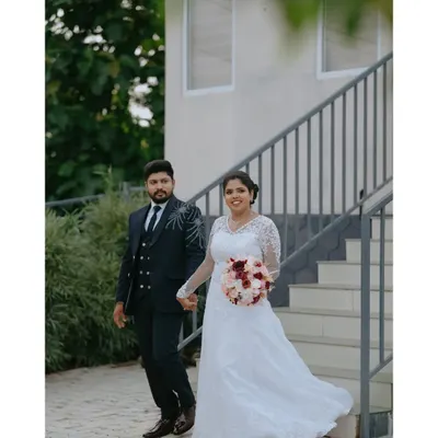 The bride and groom walk hand in hand, a perfect picture of modern elegance. This is a classic wedding portrait that captures the beginning of their journey together.