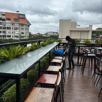 The rooftop bar at Masala Martini in Bengaluru, where we added a line of planters to create a green border with a city view. Our ongoing plant care ensures the space remains fresh, soft, and inviting for guests.