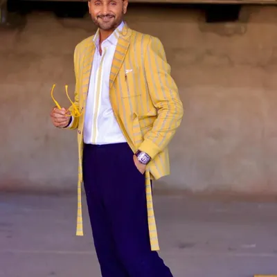 A dapper dream. Cricketer Harbhajan Singh looks sharp in this custom-crafted yellow striped blazer set. It's a defined and confident look that I was proud to create for him.