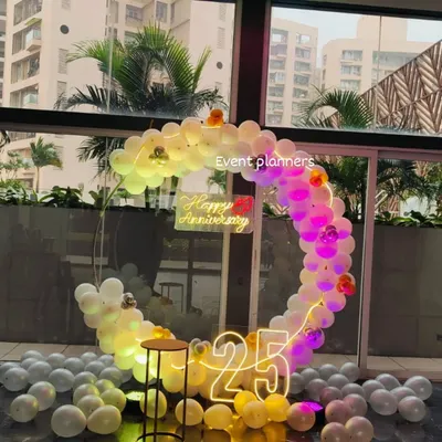 Here is another view of the 25th anniversary setup, showing how the circular balloon arch and light-up numbers create a beautiful focal point. I used a mix of white, yellow, and silver balloons to match the silver anniversary theme.