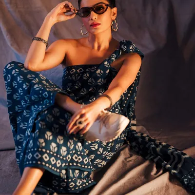 We blended traditional and street styles for this modern saree look. The pose, sunglasses, and sneakers create a chic, 'naughty hottie' vibe that's perfect for a fashion editorial.