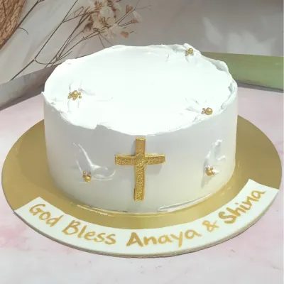 A simple and elegant confirmation cake. The pristine white design is accented with a golden cross and delicate white doves.