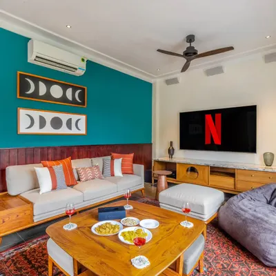 Another angle of this stylish living room, showing how the in-wall speakers and large screen TV are balanced with the room's furniture and art. This proves that high-performance AV can coexist with beautiful interior design.