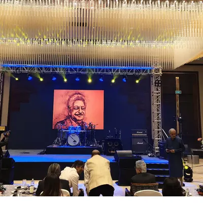 This is the stage view from my live sand art performance for a Wipro alumni event. The final sand portrait of Mr. Azim Premji is displayed on the large LED screen, showing how the art becomes the centerpiece of a major corporate function.
