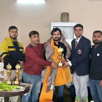 Being felicitated at a local sports event. It is an honor to be recognized by the community.