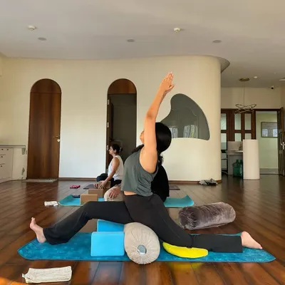 Using blocks and bolsters to support the body in Hanumanasana (the splits). This shows how we can work towards deep poses with patience and support.