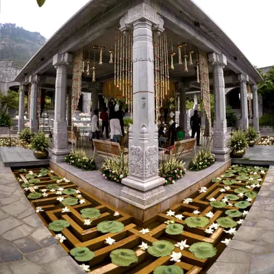 We designed a royal and romantic theme for Sonam and Ross's wedding ceremony. This stunning mandap at Amitarasa, set against the mountains, featured intricate floral hangings and a water body filled with lotuses.