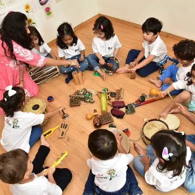 A bird's eye view of our jamming session, where little hands get to explore a variety of Indian percussion instruments. We gather in a circle to share sounds and rhythms, fostering a wonderful sense of community and musical discovery.
