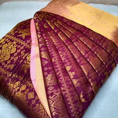 A rich purple and gold Kanjeevaram saree, with its pleats expertly set. The beauty of a silk saree is truly revealed when the pleats are uniform and crisp.