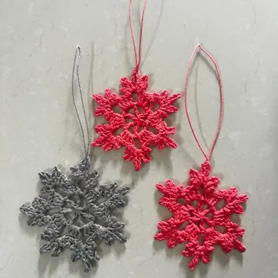Get into the festive spirit with these reusable crochet snowflake ornaments. They look beautiful on a Christmas tree and can be used as bag charms after the holidays.