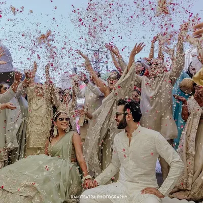 A moment of pure celebration as guests shower the couple with flower petals during their welcome lunch at Fairmont Jaipur.